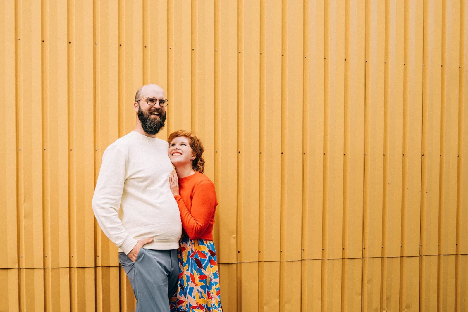 Jake and a companion posing against a tall golden wall